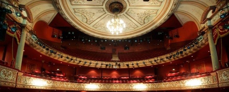 Ornate historic theater interior with a domed ceiling and balconies